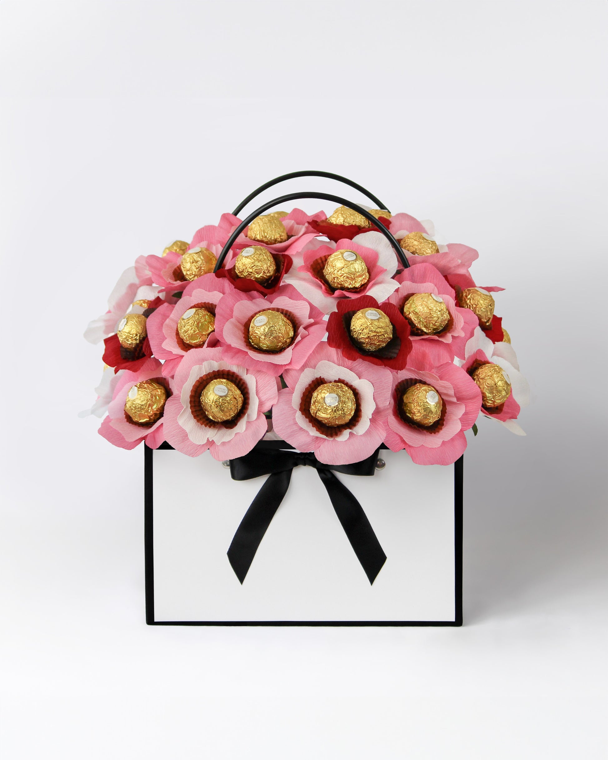 Custom gift bouquet featuring soft sunset hues and chocolate-centred blooms