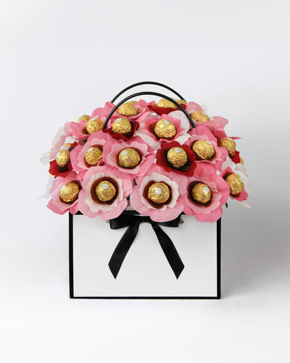 Custom gift bouquet featuring soft sunset hues and chocolate-centred blooms