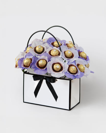 Soft purple floral arrangement with chocolate centres in Lavender bloom box