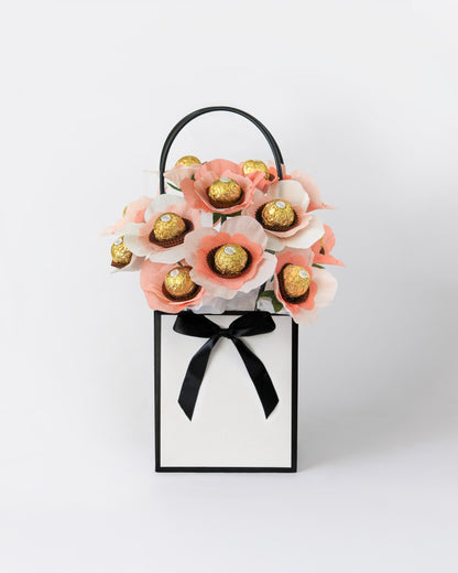 Sweet floral arrangement in creamy tones with hidden chocolate centres